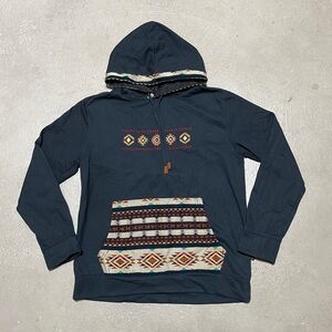 Hoodie with southwestern embroidery on chest and southwestern fabric on pocket.